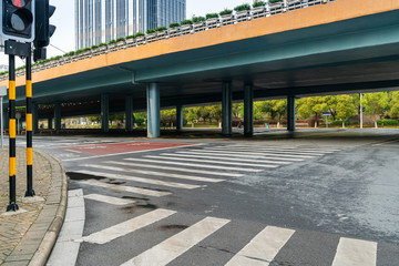 Concrete structure and asphalt road space under the overpass in the city