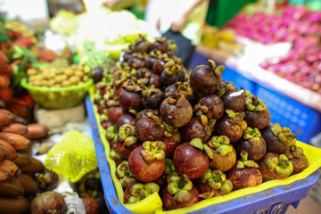 Garcinia mangostana fruit in a shop window in a market.