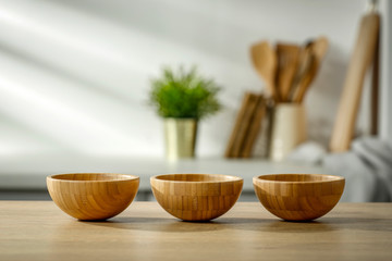 Wooden table in the kitchen with incoming morning sunlight with free space for an advertising product