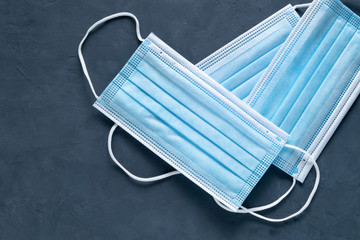 Close-up medical masks against a dark background. A symbol of a pandemic, the protection of the...