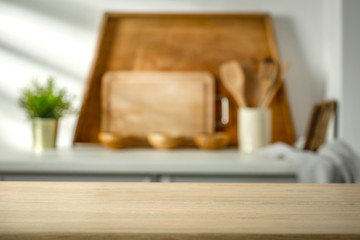 Wooden table in the kitchen with incoming morning sunlight with free space for an advertising product