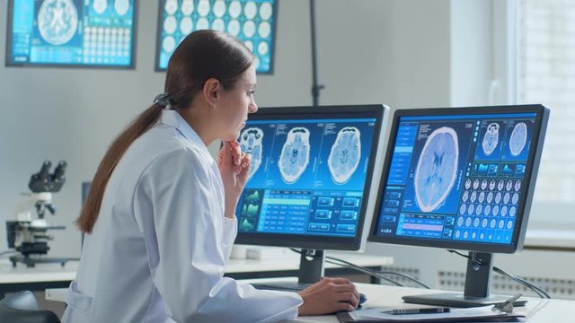 Professional medical doctor working in hospital office using computer technology. Medicine, neurosurgery and healthcare.