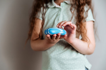A girl holding soap in her hands.