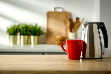 Wooden table in the kitchen with incoming morning sunlight with free space for an advertising product
