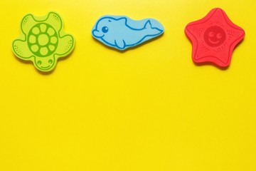 flatlay toys on a yellow background. Marine life.Mockup for design with copy space.