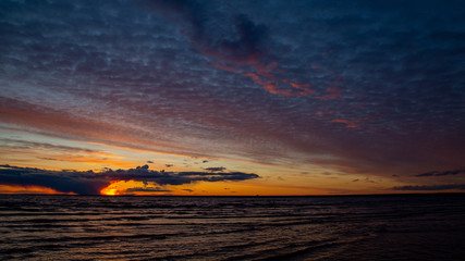 Sunset on the beach, dramatic sky, dramatic clouds.