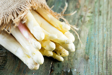Freshly picked natural organic bunch of white asparagus vegetables on a wooden background.