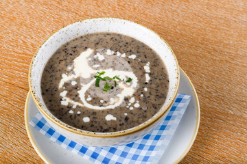 Mushroom cream soup. Chanterelle cream soup on wooden background, selective focus