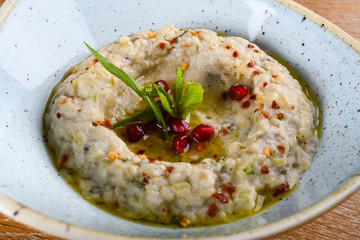 Baba ghanoush, also spelled baba ganoush or baba ghanouj, is an appetizer of mashed cooked eggplant