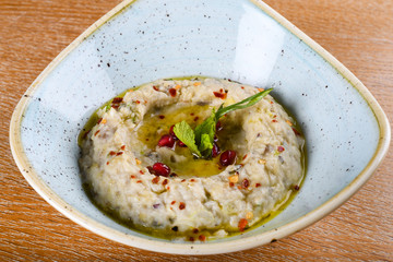 Baba ghanoush, also spelled baba ganoush or baba ghanouj, is an appetizer of mashed cooked eggplant