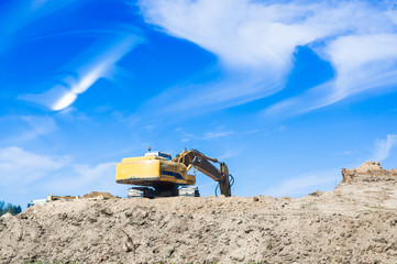 Construction excavator on a background of blue sky
