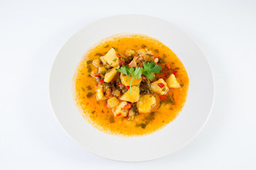Potatoes Stew with vegetable on white plate. Traditional romanian food.
