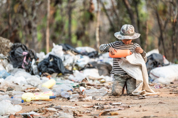Poverty in India, a child collects garbage in a landfill site, Concept of livelihood of poor...