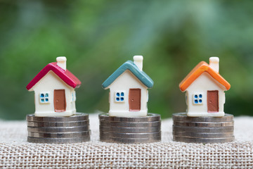 miniature houses among pile of coins, Housing industry mortgage plan and residential tax saving...