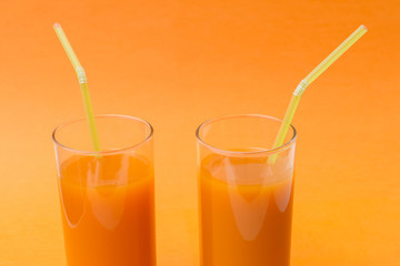 glass of orange juice and oranges