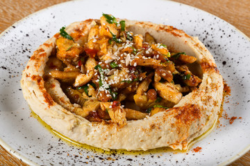 Hummus is a dip, spread, or savory dish made from cooked, mashed chickpeas