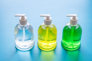 Sanitazer and soap for hands - infection disease prevention - on blue table
