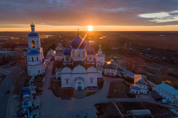 Sun rising over the All-Saints Bell Tower and Our Lady of Bogolyubovo Church in the village of Bogolyubovo, Vladimir region, Russia