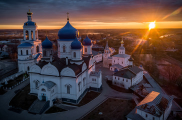Sun rising over the All-Saints Bell Tower and Our Lady of Bogolyubovo Church in the village of Bogolyubovo, Vladimir region, Russia