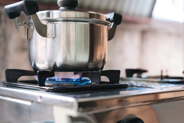 Stainless pot on gas stove.