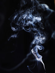 White cigarette smoke on a black background