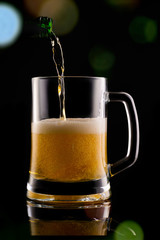 Beer with foam on black background