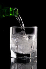Glass of mineral water on black background