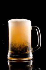 Beer with foam on black background