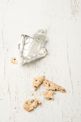 leftover crumbs of biscuits and cheese on table