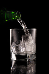 Glass of mineral water on black background