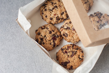 Fresh organic homemade cookies with chocolate chips and dried berries on box