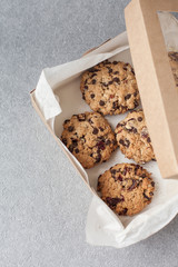Fresh organic homemade cookies with chocolate chips and dried berries on box