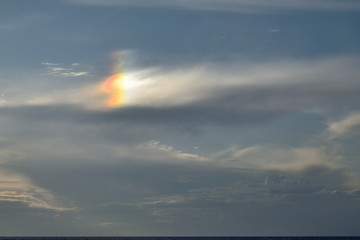 rare optical phenomenon, especially in mid-summer: sun dog (parhelia) produced by the reflection and refraction of sunlight through ice crystals - Therma beach, Samothraki island, Greece, Aegean sea
