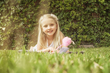 Summertime fun. Cute Blond Girl writing in the notebook. Keeping her secrets in diary.