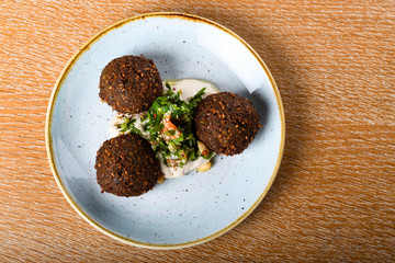 Falafel is a deep-fried ball, or a flat or doughnut-shaped patty, made from ground chickpeas