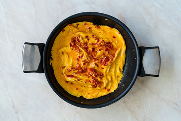 Omelette with Sweet Red Bell Capia Pepper in Pan for Breakfast Top View.