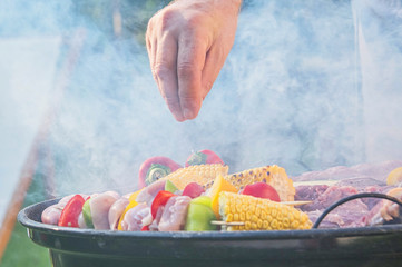 Summertime fun. Barbecue for summer family dinner in the backyard of the house.