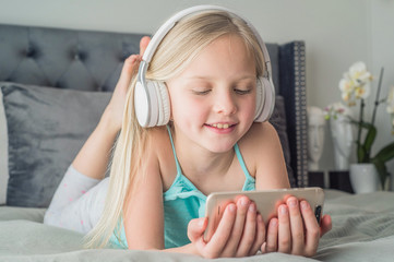 Pre teen girl playing on tablet. Virtual class lesson on video during self isolation at home. Distant remote video education. Modern school study for kids.