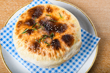 Fish stew in a white bowl, served with a pita bread cover on top. Levantine East Mediterranean food