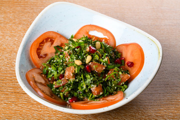 Tabbouleh is a Levantine vegetarian salad made mostly of finely chopped parsley, with tomatoes, mint