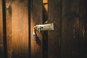 Nahaufnahme von einem offenen rostigen Vorhängeschloss an einem Schuppen