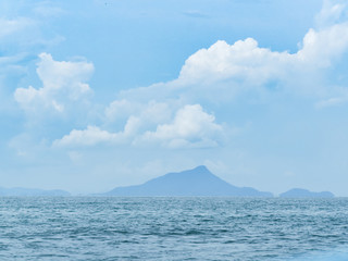 Shadow mountains look through the sea.