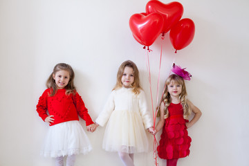 Girls friends on holiday with red balloons