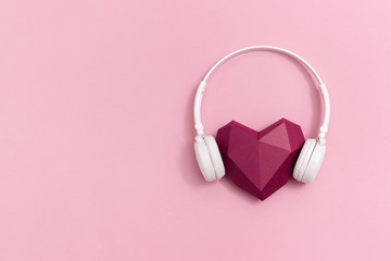 3d dark red paper heart in white headphones. Concept for music festivals, radio stations, music lovers.  Live with music. Minimal style. Copy space.