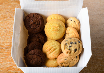 Homemade vanilla, orange, lemon chocolate chip cookies biscuits stack on a white plate