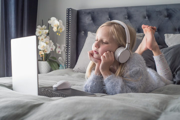 Pre teen girl playing on tablet. Virtual class lesson on video during self isolation at home. Distant remote video education. Modern school study for kids.