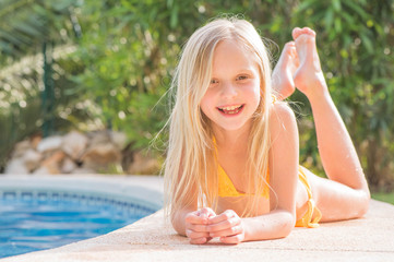 Summertime fun. Happy girl in pool in sunny day. Vacations.
