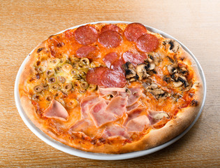 Pizza quattro stagioni is a variety of pizza in Italian cuisine that is prepared in four sections