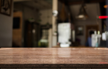 Empty old wood table top with bokeh coffee shop interior background.g