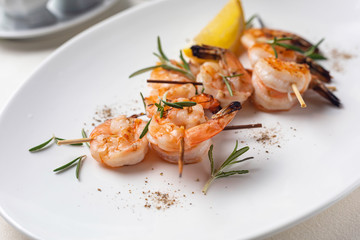 grilled shrimp on a white plate in a restaurant